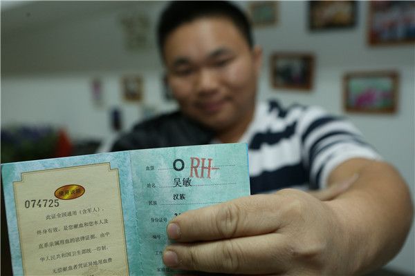 O型Rh阴性血的吴敏展示他的献血证.jpg